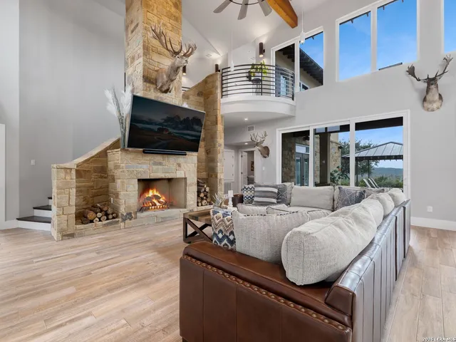 a living room with furniture a flat screen tv and a fireplace