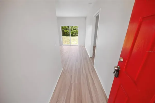 a view of a room with wooden floor and a window