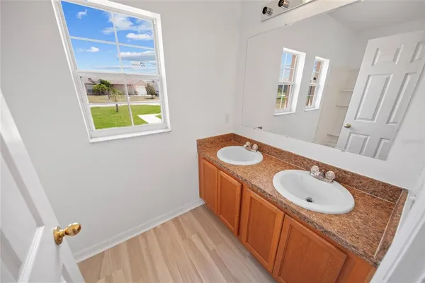 a bathroom with a sink toilet and mirror