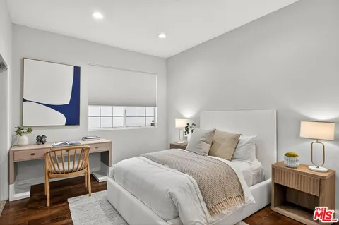 a bedroom with a bed a lamp and a window