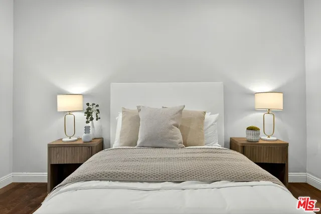 a bedroom with a bed and a night stand