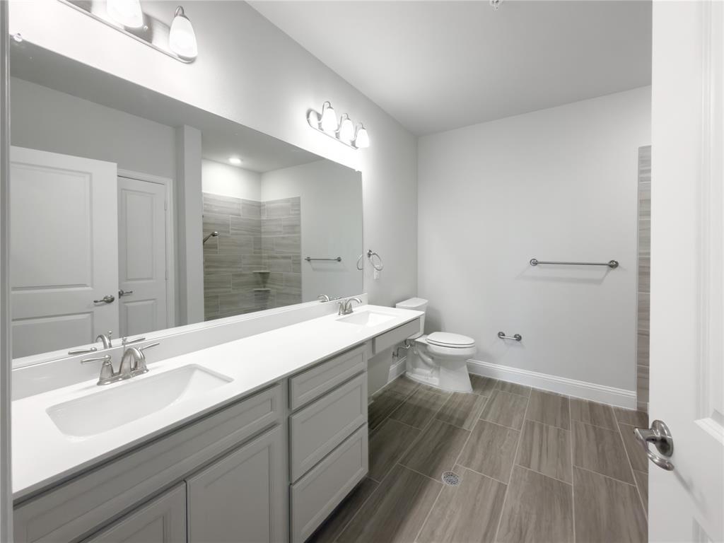 651 Watters Road, Unit 4202 Allen, TX 75013 - Photo 11 of 24 a bathroom with a sink a toilet a large mirror and shower