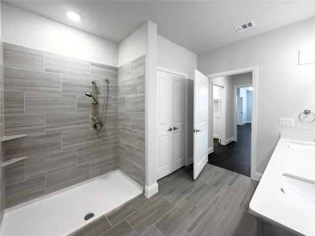 a bathroom with a bathtub and a shower