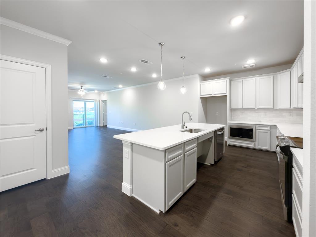 651 Watters Road, Unit 4202 Allen, TX 75013 - Photo 4 of 24 a kitchen with a stove and a sink