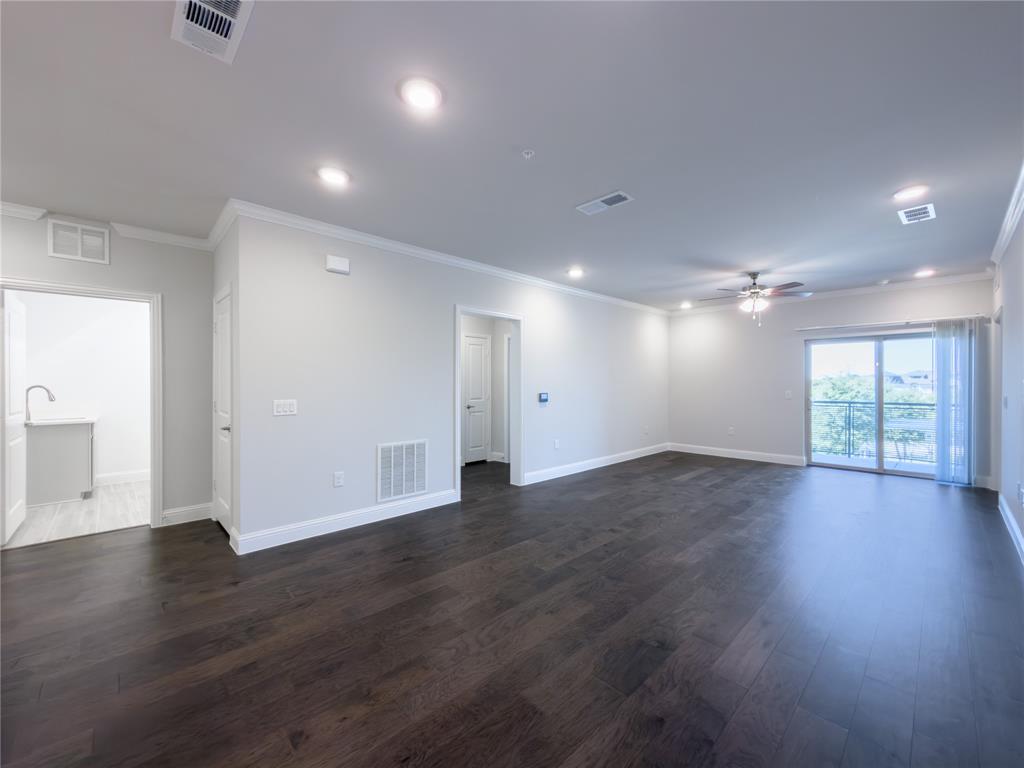 651 Watters Road, Unit 4202 Allen, TX 75013 - Photo 5 of 24 an empty room with wooden floor and windows