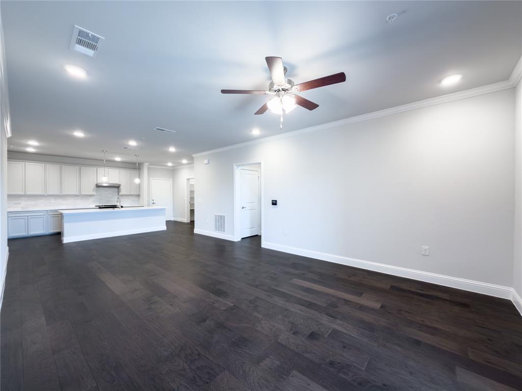 651 Watters Road, Unit 4202 Allen, TX 75013 - Photo 6 of 24 an empty room with wooden floor and windows