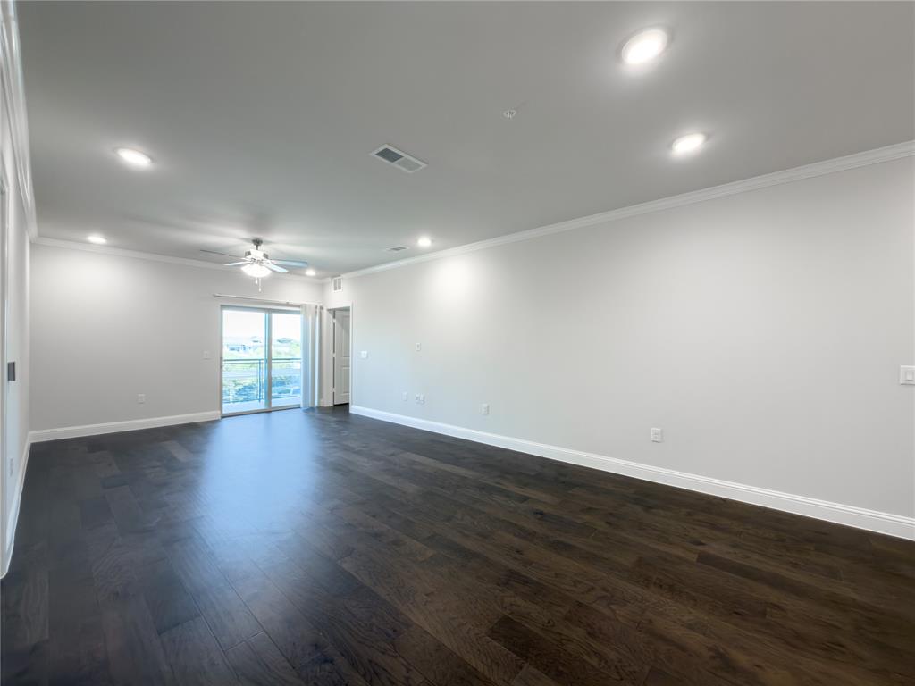 651 Watters Road, Unit 4202 Allen, TX 75013 - Photo 7 of 24 an empty room with wooden floor and windows