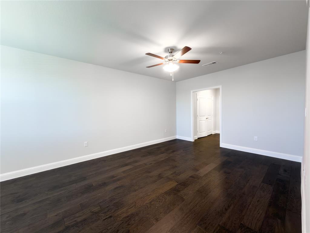 651 Watters Road, Unit 4202 Allen, TX 75013 - Photo 8 of 24 a view of an empty room with wooden floor and a window