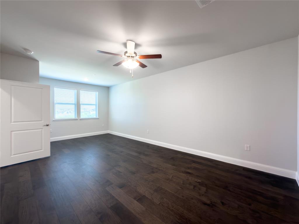 651 Watters Road, Unit 4202 Allen, TX 75013 - Photo 10 of 24 a view of an empty room with wooden floor and a window