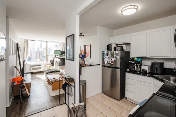 a kitchen with a refrigerator and a sink