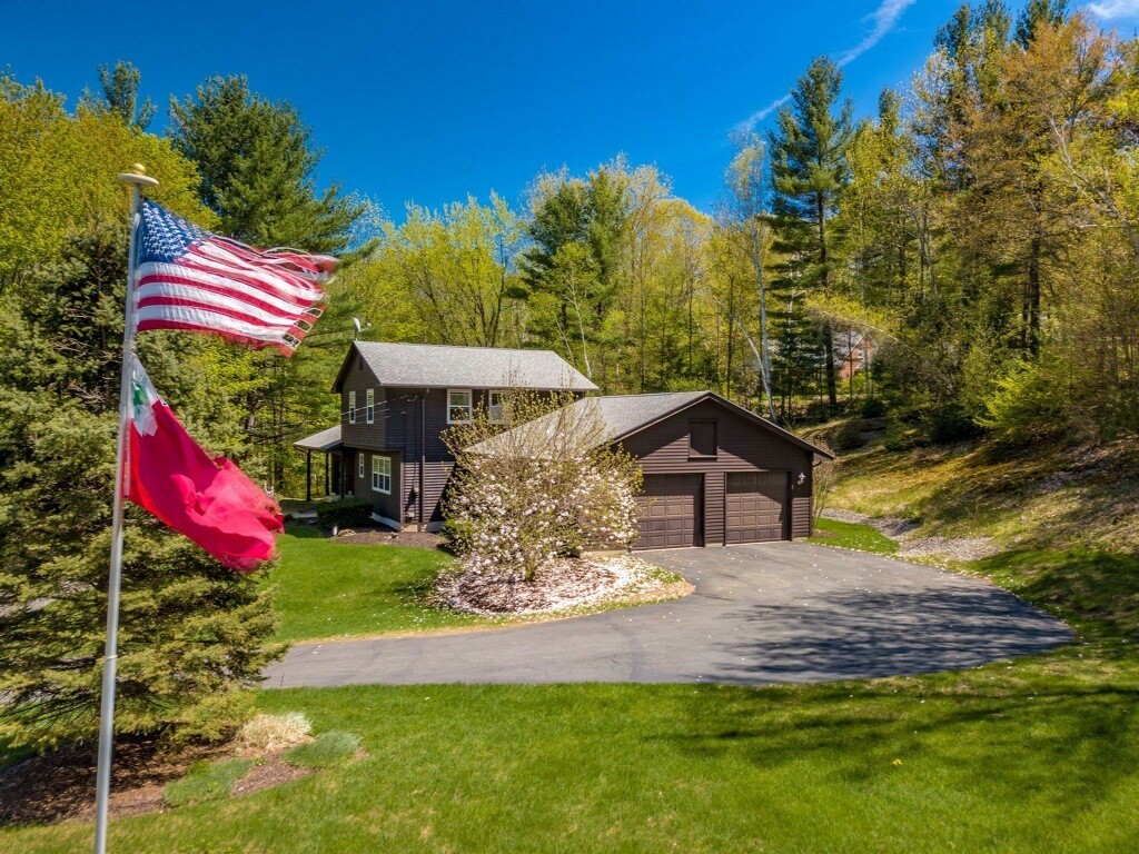 843 Blandford Road Russell, MA 01071 - Photo 1 of 27 a front view of a house with a yard