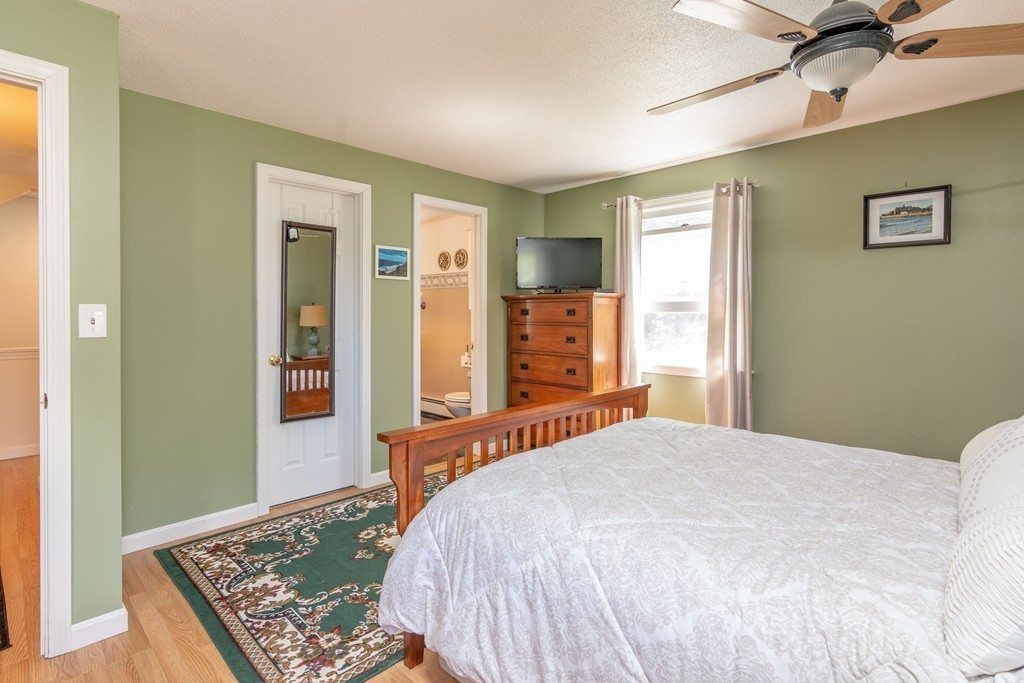 843 Blandford Road Russell, MA 01071 - Photo 16 of 27 a bedroom with a large bed and a chandelier