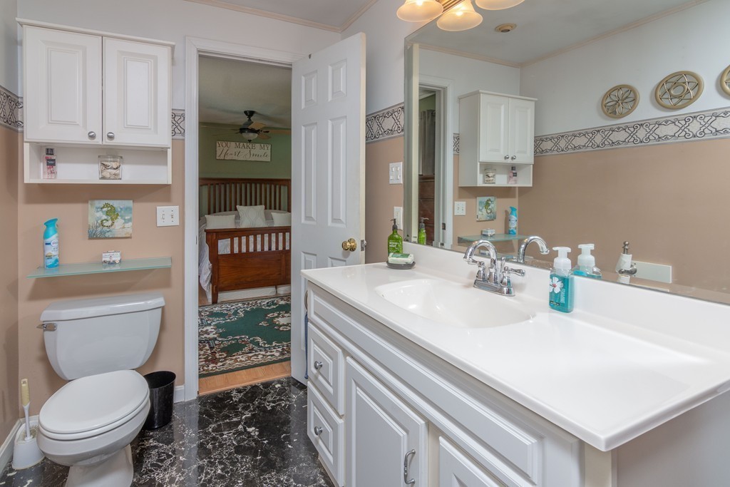 843 Blandford Road Russell, MA 01071 - Photo 17 of 27 a bathroom with a granite countertop toilet sink and mirror