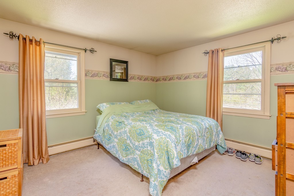 843 Blandford Road Russell, MA 01071 - Photo 19 of 27 a bed sitting in a bedroom next to a window