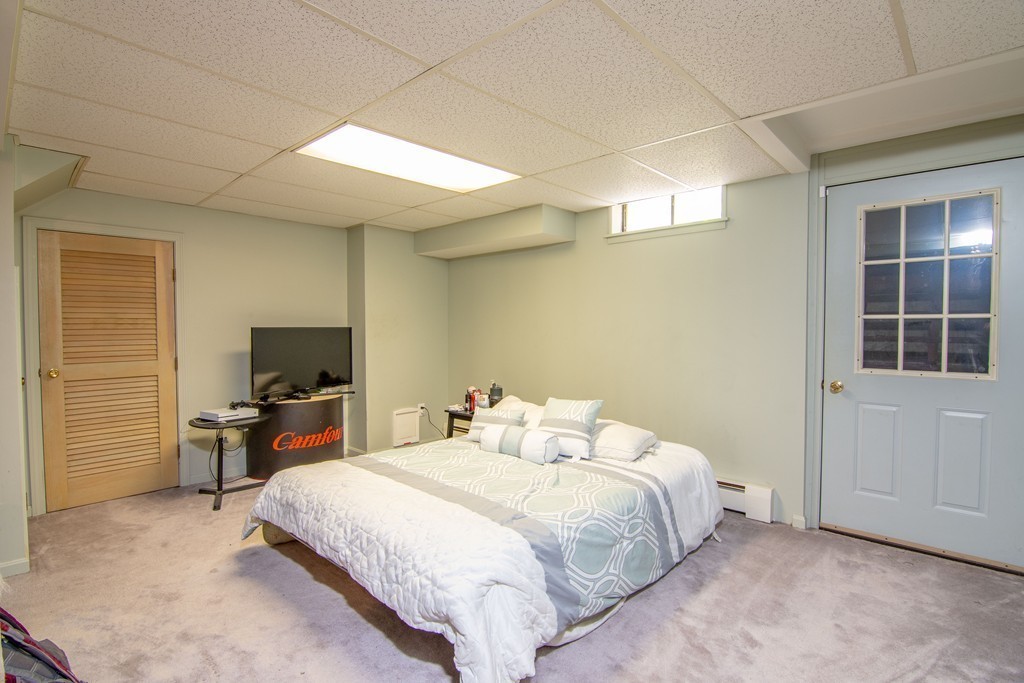 843 Blandford Road Russell, MA 01071 - Photo 22 of 27 a bedroom with a bed and a flat tv screen in it