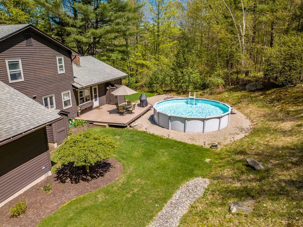 843 Blandford Road Russell, MA 01071 - Photo 4 of 27 a aerial view of a house with table and chairs under an umbrella