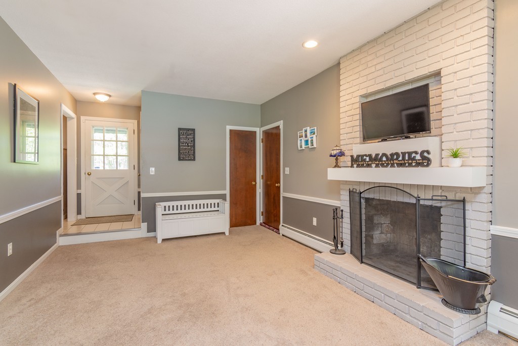 843 Blandford Road Russell, MA 01071 - Photo 5 of 27 a view of an empty room with a fireplace