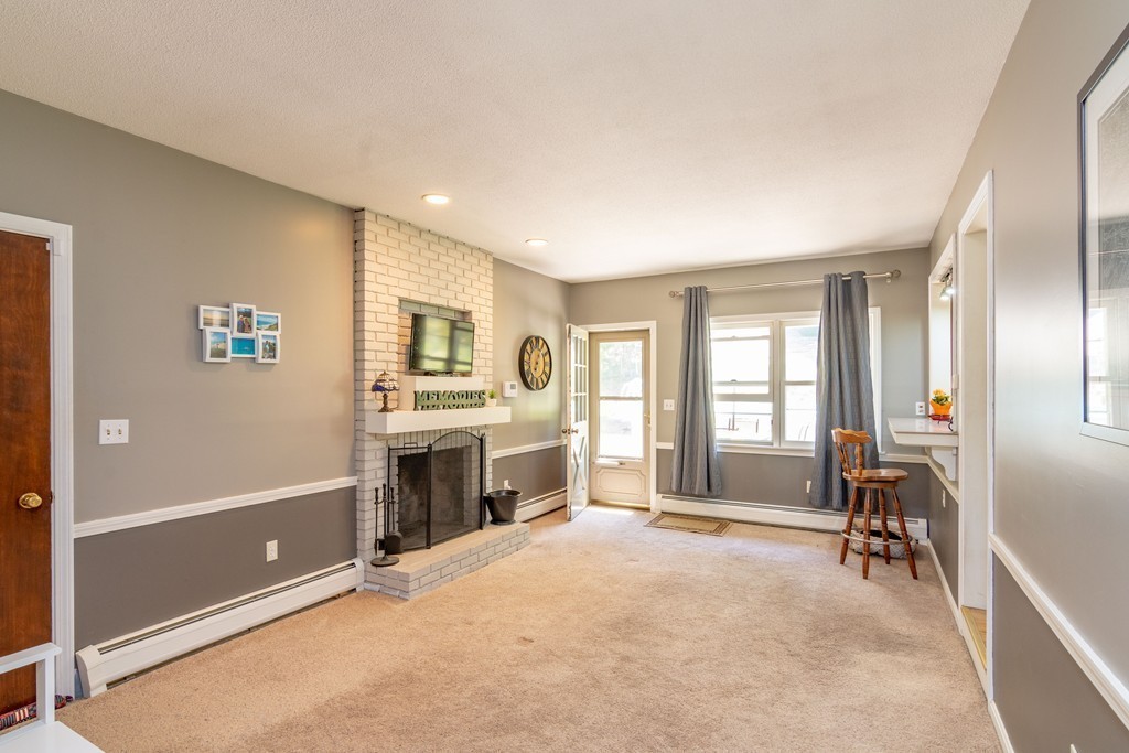 843 Blandford Road Russell, MA 01071 - Photo 6 of 27 a living room with furniture and a fireplace