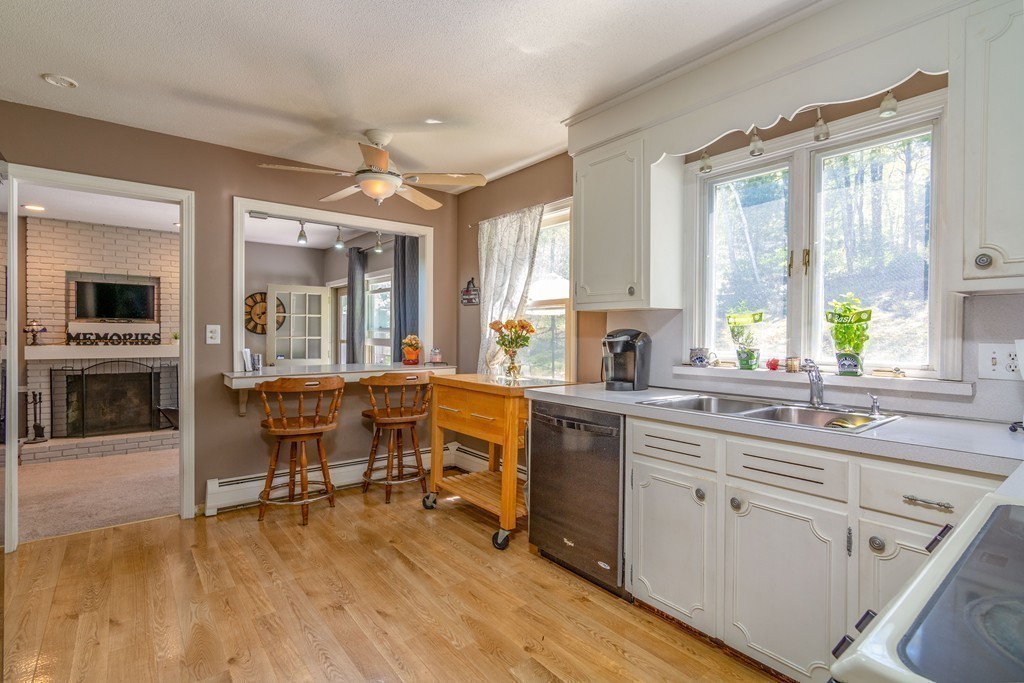 843 Blandford Road Russell, MA 01071 - Photo 9 of 27 a kitchen with a sink cabinets and dining table chair