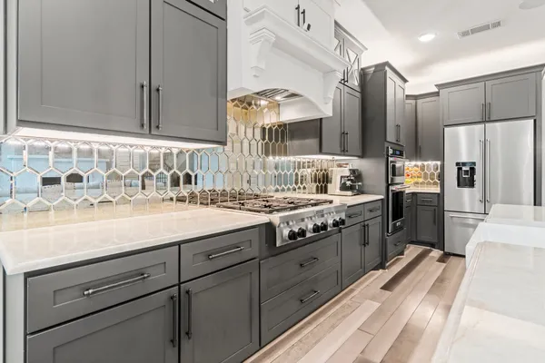 a kitchen with stainless steel appliances granite countertop a sink stove and refrigerator