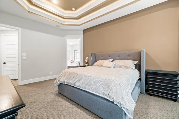 a large bed sitting in a bedroom next to a window