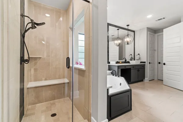 a bathroom with a tub sink and mirror