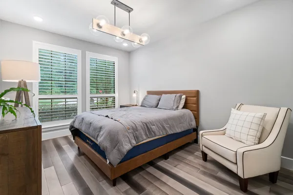a bedroom with a bed and a chandelier