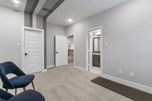 a porch with a table and chairs and potted plants