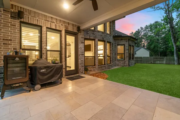 a front view of a house with a yard table and chairs