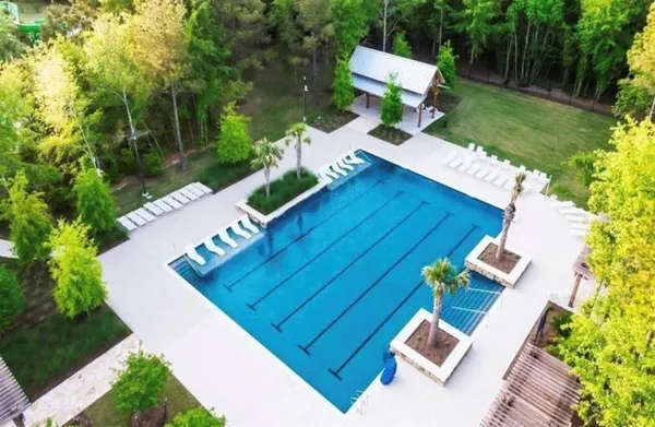 a park view with a bench under an umbrella