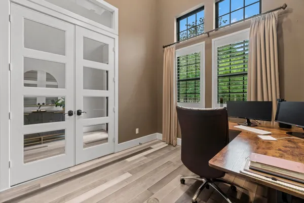 a view of a workspace with furniture and a window
