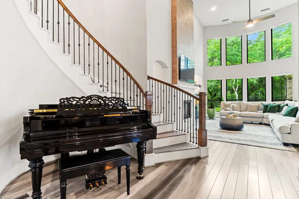 a living room with furniture and a floor to ceiling window