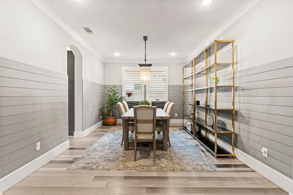 a dining room with furniture a rug and wooden floor