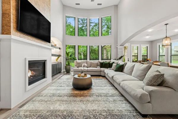 a living room with furniture a flat screen tv and a fireplace