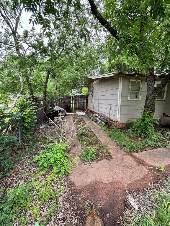 1918 North 6th Street, Unit R Wichita Falls, TX 76301 - Photo 14 of 14 a backyard of a house with lots of green space