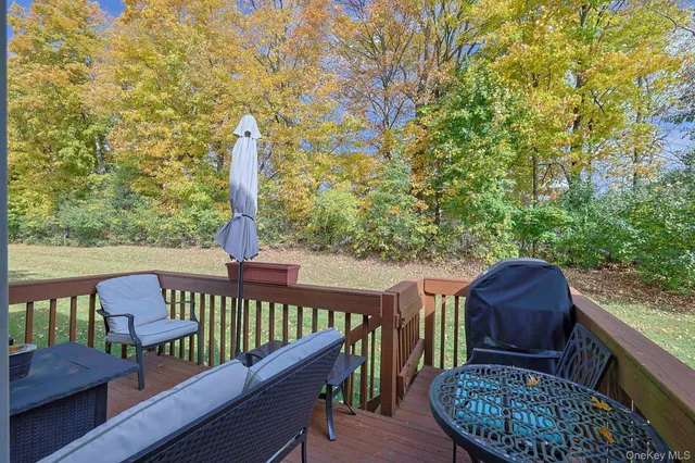 a view of a deck with wooden floor and outdoor seating