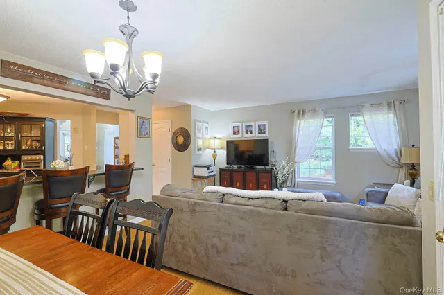a living room with furniture a large window and a flat screen tv