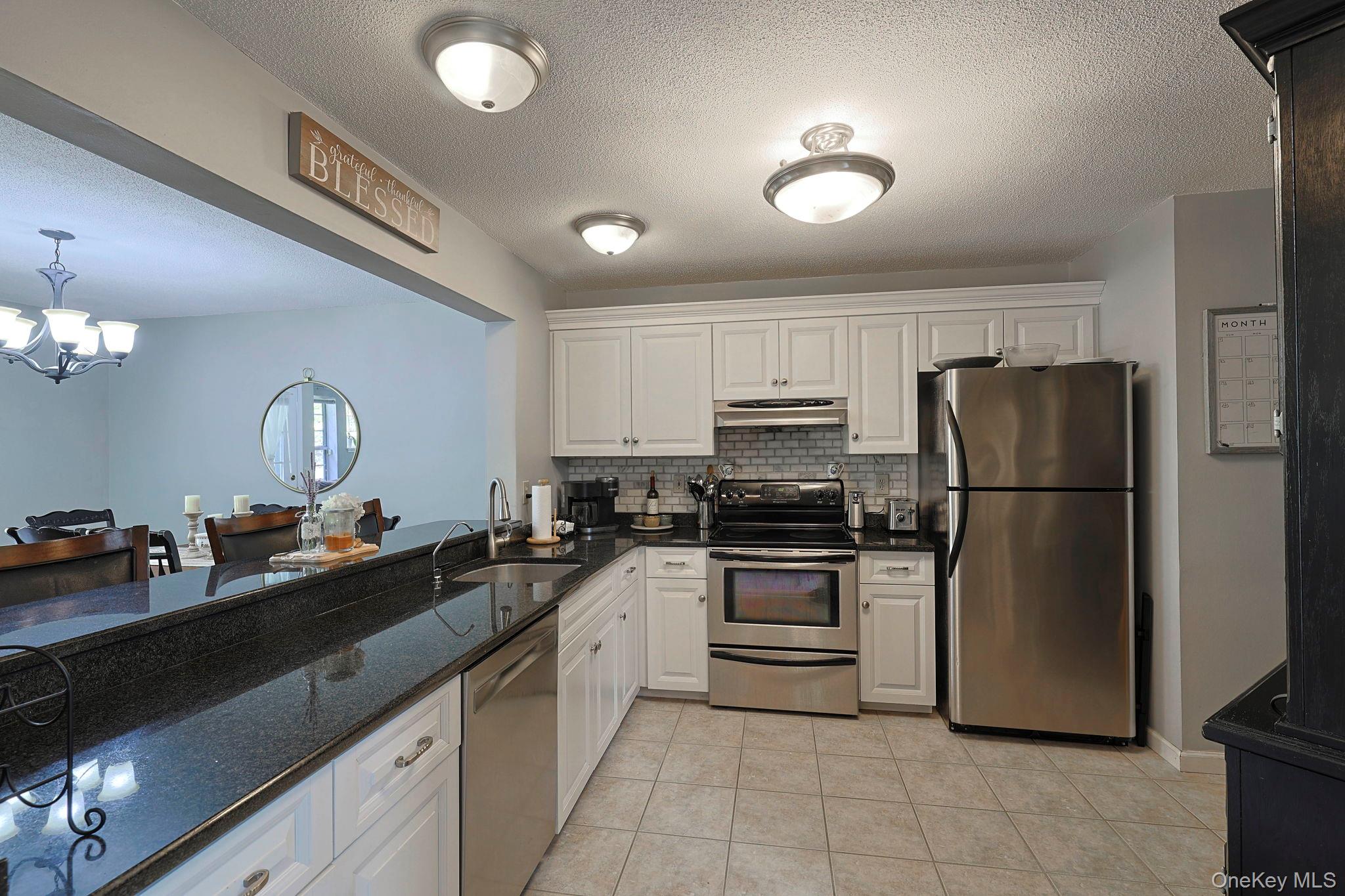209 Crestwood Court Fishkill, NY 12524 - Photo 10 of 23 a kitchen with a sink appliances and cabinets