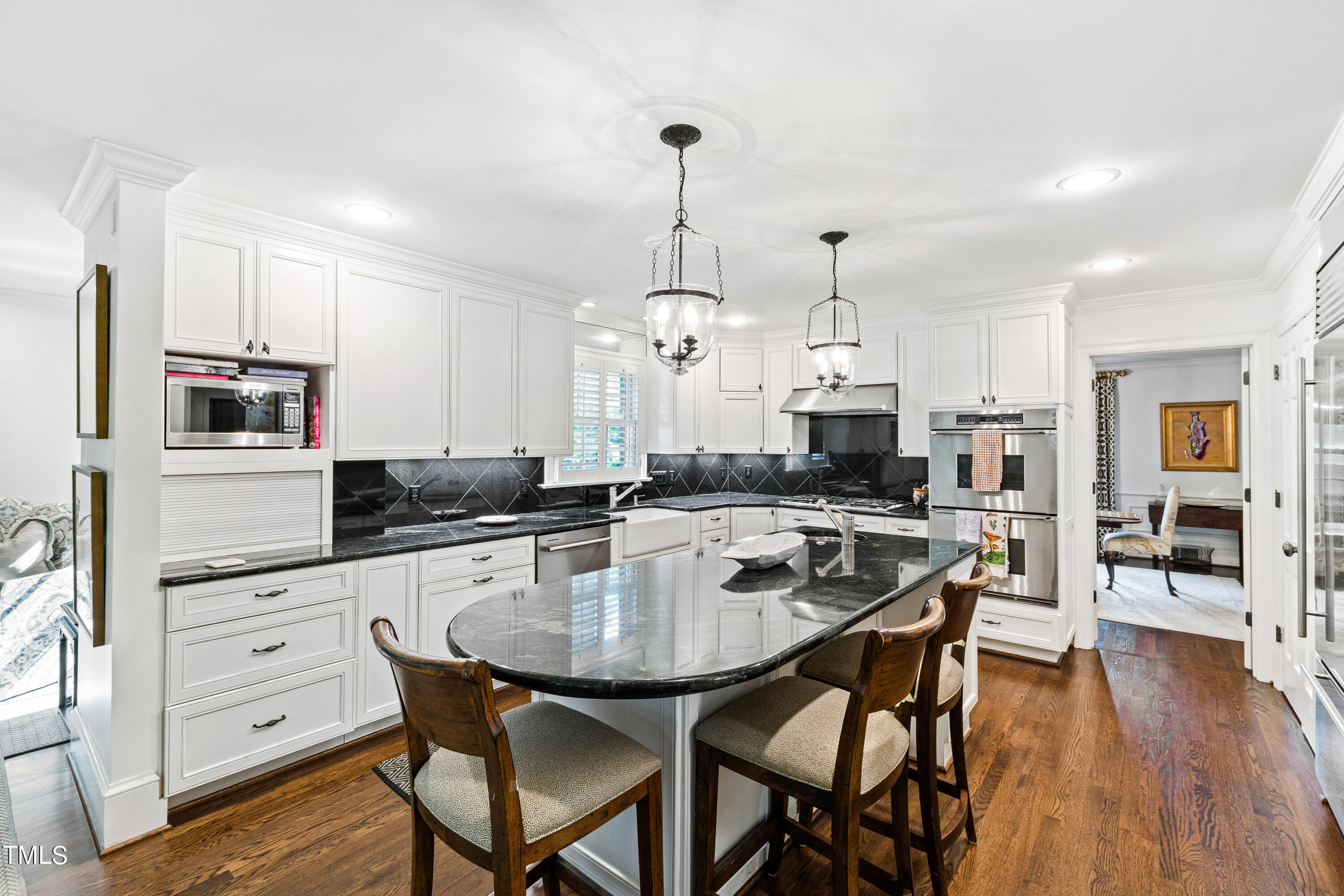 2525 White Oak Road Raleigh, NC 27609 - Photo 16 of 58 a kitchen with stainless steel appliances a dining table chairs stove and refrigerator