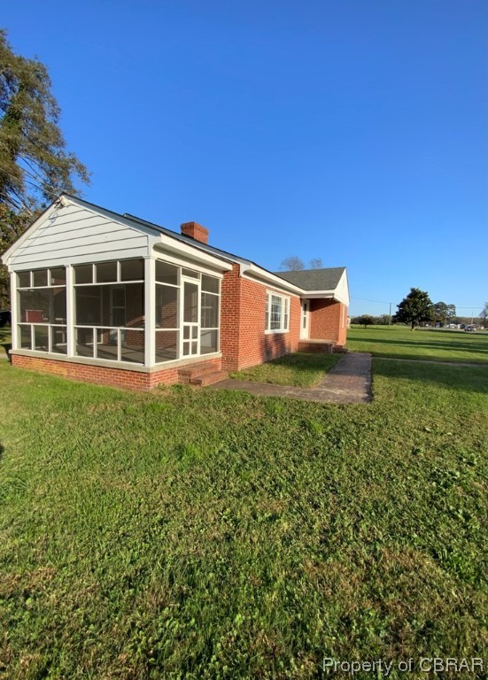 14 Light Street Heathsville, VA 22473 - Photo 2 of 18 Rear view of house with a sunroom and a lawn