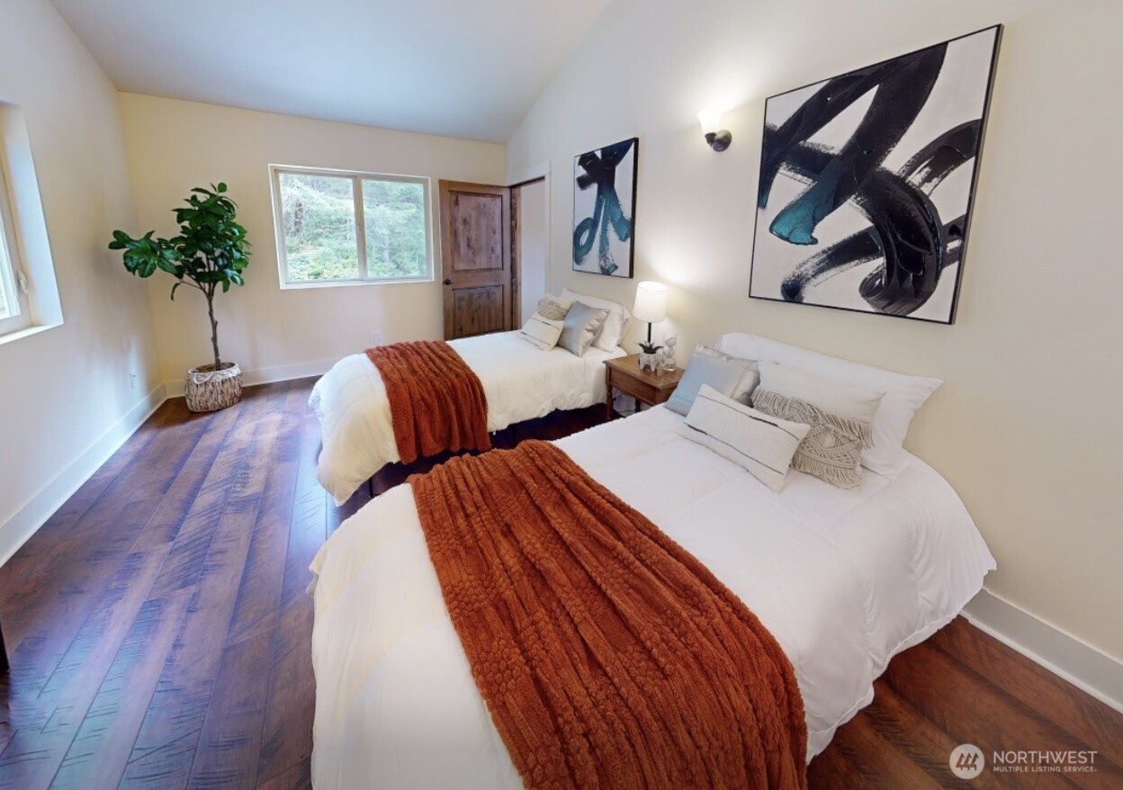 83 Octopus Court Quilcene, WA 98376 - Photo 29 of 40 a bedroom with two beds and a potted plant