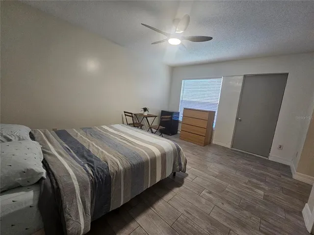 a view of a workspace with furniture and wooden floor