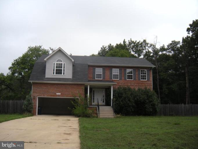 17111 Livingston Road Accokeek, MD 20607 - Photo 1 of 1 a front view of a house with a yard and garage