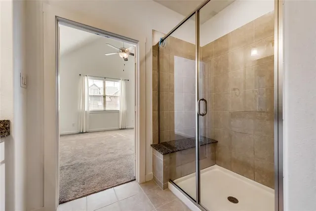 a bathroom with a shower and a sink