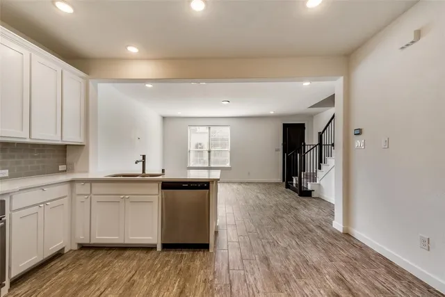 a kitchen with granite countertop a sink and cabinets