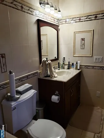 a bathroom with a sink vanity mirror and toilet