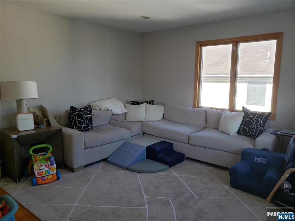 152 Miller Avenue, Unit 2 Elmwood Park, NJ 07407 - Photo 4 of 15 a living room with furniture and a window