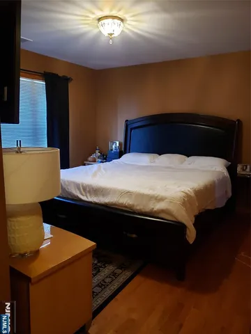 a bed sitting in a bedroom next to a lamp