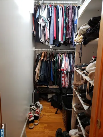 a view of walk in closet with clothes