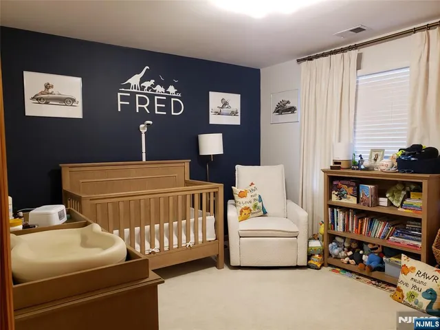 a bedroom with furniture and a book shelf